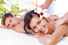 Beautiful young couple receiving massages at a spa